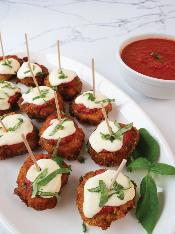 Chicken Parmesan Bites served with dipping sauce.