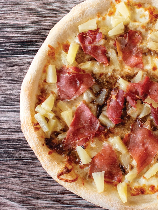 Italian Hawaiian Pizza with pineapple and ham.