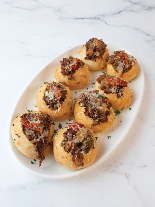Mini cheesesteaks with peppers and onions.