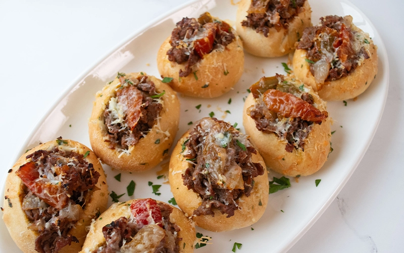 MINI CHEESESTEAKS WITH PEPPERS & ONIONS