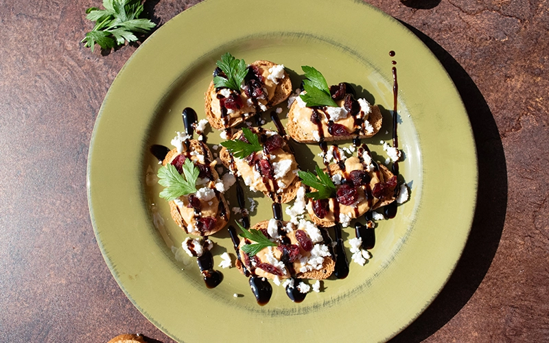 Pumpkin Hummus Crostini with Dried Cranberries and Feta