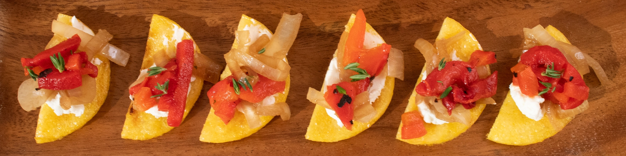 Grilled Polenta Moons with Roasted Red Peppers and Sauteed Onions