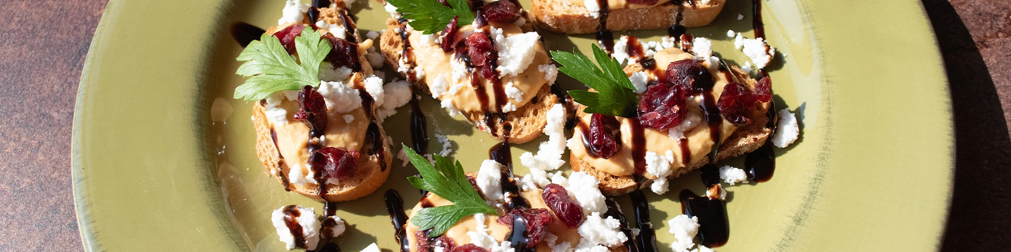 Pumpkin Hummus Crostini with Dried Cranberries and Feta