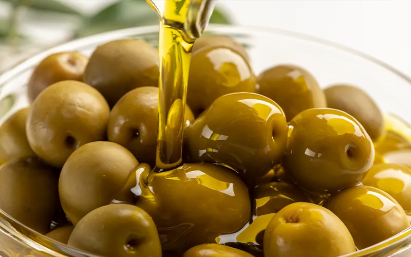 olive oil being poured on olives